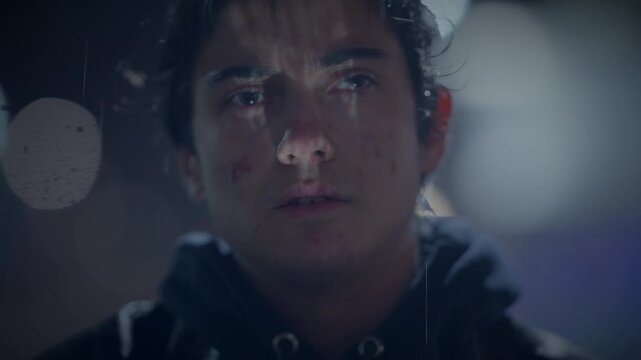A young man is lost in thought on a rainy night, embraced by solitude, city lights, and rain