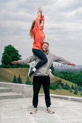 in the park young couple in love doing sports couples warming up a healthy lifestyle synchronized...