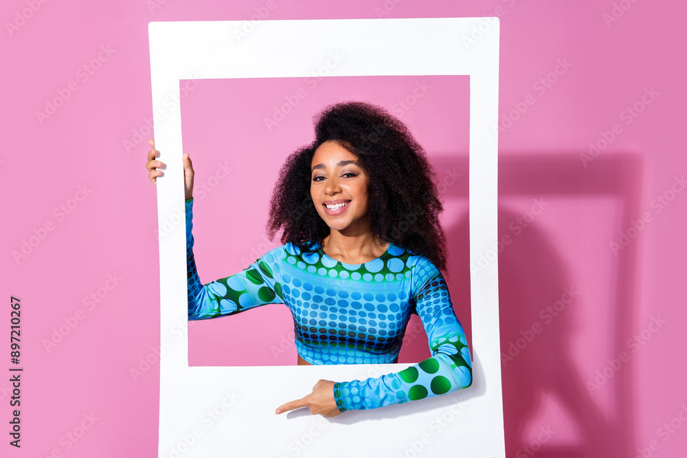 Poster Photo of lovely young lady instant photo frame cute point empty space dressed stylish blue garment isolated on pink color background