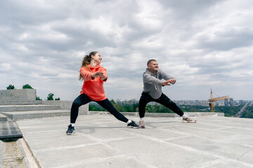 in the park a young couple in love doing sports couples warming up healthy lifestyle synchronized...