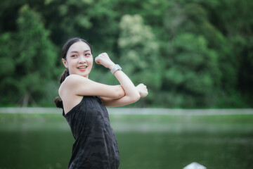 A young woman jogs in the city on a summer morning, embodying an active lifestyle. This fit athlete, dressed in sports clothing, enjoys outdoor exercise, promoting health, vitality, and a healthy life