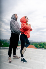 in the park a young couple in love doing sports couples warming up healthy lifestyle synchronized...