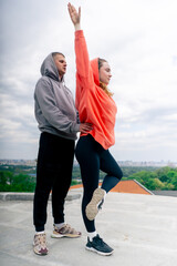 in the park a young couple in love doing sports couples warming up healthy lifestyle synchronized...
