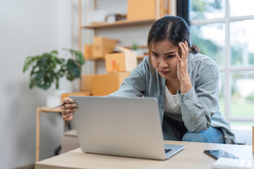 Stressed Young Woman Selling Items Online from Home, Experiencing Frustration and Anxiety While...