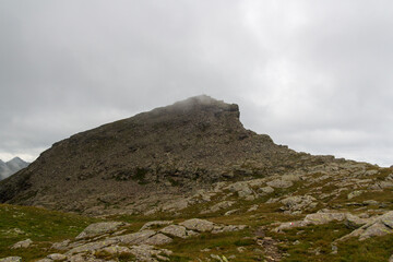 Mountain summit Spronser Rötelspitze in the clouds in Texel group, South Tyrol, Italy