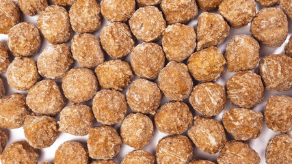 Frozen meatballs filling the frame, top down view studio shot on white background