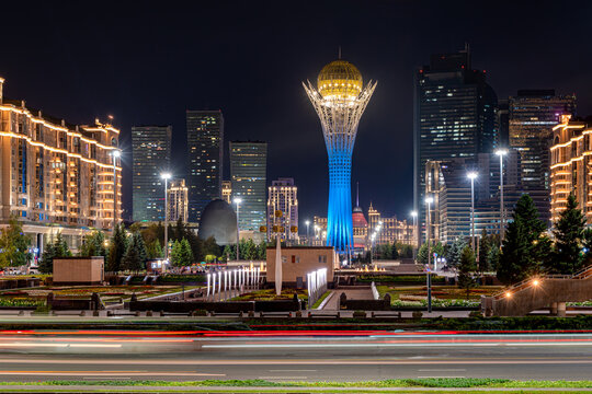 Nighttime view of the Kazakh capital, Astana, with the iconic Baiterek Tower at the center. This is a monumental observation tower and a famous tourist attraction