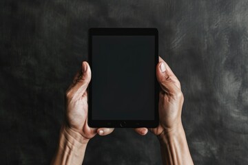 A person holding a black tablet computer in their hands, suitable for technology and innovation concept images