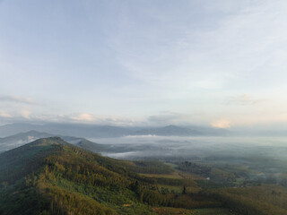 Aerial view sunrise morning on mountain peak tropical rainforest with fog