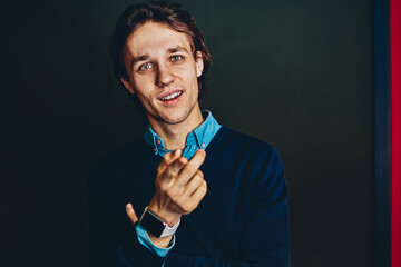 Portrait of handsome young businessman pointing on you enroll for vacancy and successful career, caucasian man need you for hire in team for startup creation looking at camera standing indoors