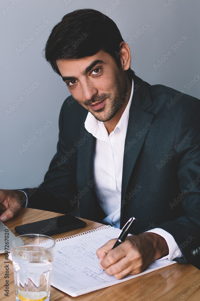 Aufkleber portrait of smiling male graphic designer creating logotyp for company via laptop device and writing