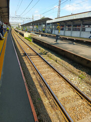 Railway tracks at Cilebut Station, Bogor, capturing a quiet moment at a suburban train stop, perfect for transportation, travel, and urban landscape projects