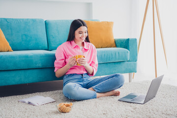 Photo of adorable sweet lady wear pink shirt staying home drinking tea watching video modern device indoors room home house