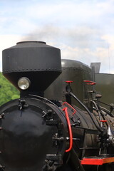 close-up of the black and red historic steam locomotive of the Bieszczady Forest Railway