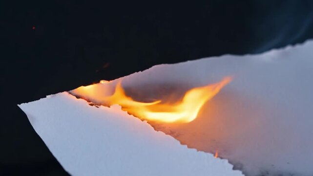 Burning white paper. burning paper, glowing edge of paper on a black background
