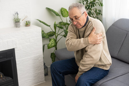 an elderly man hurts his elbow