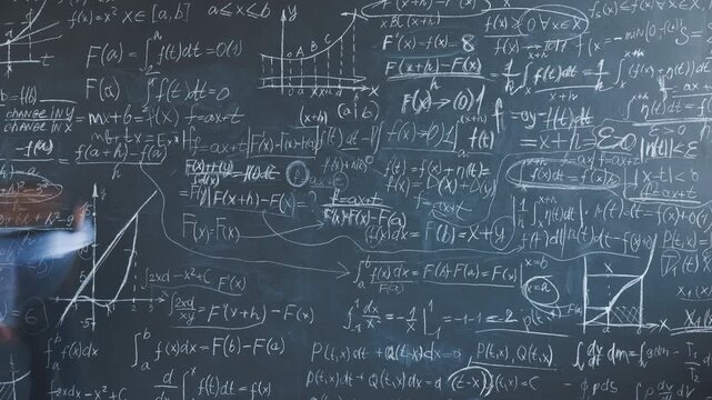 Time lapse of genius kid writing formulas on chalkboard working at academic research studying in classroom in school. Education and childhood concept.