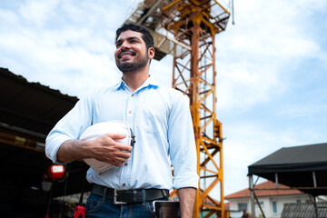 Portrait of engineer with tower crane for lift and move objects on building construction sites