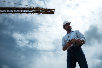 Portrait of engineer with tower crane for lift and move objects on building construction sites