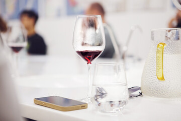  Wine glass poured with red wine on table during training. 