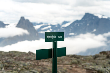 Sign of reaching Mjolvafjellet mountain with viewpoint over Andalsnes. with mountains and snow and clouds in the background