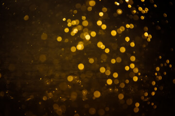Blurred photo with golden dots visible glittering, shining brightly look and feel luxurious Suitable for use as a wallpaper