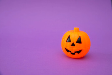 Halloween pumpkin on purple background