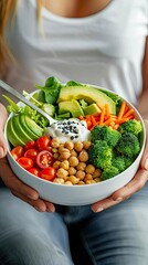 A vibrant bowl of fresh vegetables, chickpeas, and yogurt, promoting healthy eating and nutrition.