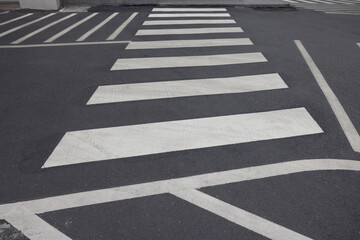 A black and white street with a white crosswalk