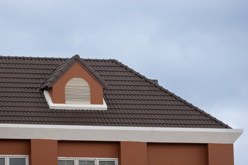 A brown roof with a garret house and a window © Rattanachat