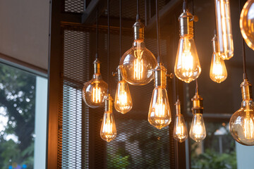 A bunch of light bulbs hanging from the ceiling