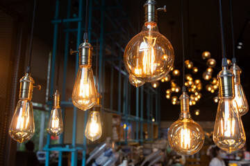 A series of light bulbs hanging from the ceiling, some of which are lit up