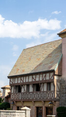 Walking area with shops and restaurants in United Arab Emirates. Riverland, Dubai. Timber framing or post-and-beam construction. Houses in style of medieval Europe. Vertical image