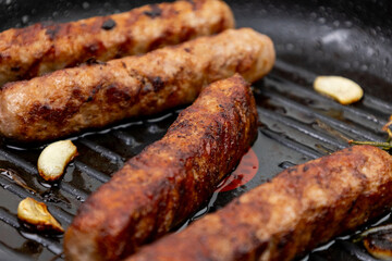 Sausages on grill pan close-up