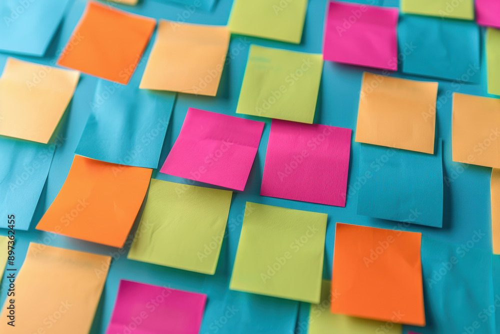 Poster colorful sticky notes arranged randomly on a blue background, creating a vibrant and organized yet c
