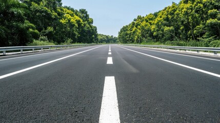 Fototapeta premium A long, empty highway with a white line down the middle. The road is empty and there are no cars or other vehicles