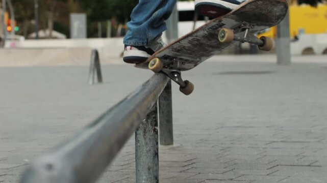 Young skater making 360 flip jump, performing kickflip trick, skateboarder training in skatepark, making tricks, slides and flips, professional extreme sport athlete training ride on skateboard. 
