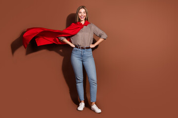 Photo of cheerful pretty nice woman wear red cape mantle empty space isolated on brown color background