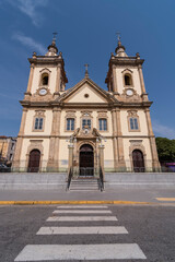 Aparecida, Brazil. Facade of the old Basilica of Nossa Senhora Aparecida in baroque architecture from 1888. Located in  it is a national sanctuary. Background blue sky.