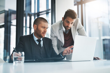 Businessmen, laptop and question for discussion in office, accounting agency and teamwork for project. Collaboration, support and mentorship with internship, planning and problem solving for finance