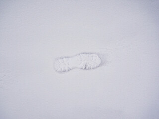 Footprint in the snow, top down view