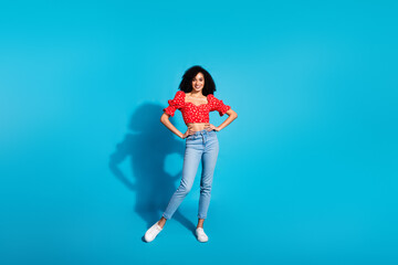 Full body portrait of gorgeous young woman posing wear top isolated on blue color background