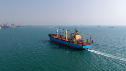 Obraz premium container,container ship in import export and business logistic,By crane,Trade Port , Shipping,cargo to harbor.Aerial view,Water transport,International,Shell Marine,transportation,logistic,trade,port