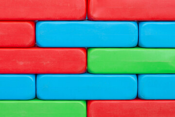 Brick wall texture. Colorful plastic toy blocks. Vibrant children's construction. Playful and creative twist on classic masonry. Empty copy space kinder background. Kindergarten blank blocks.