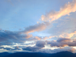 Fototapeta premium Beautiful sunset orange sky with clouds combined with blue sky