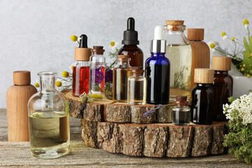 Aromatherapy. Different essential oils and flowers on wooden table