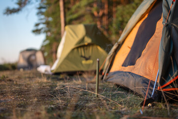 Mosquito repellent stick with smoke in forest on nature near camping tent. Smouldering insecticide...