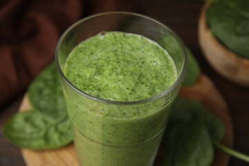 Tasty green smoothie in glass on table, closeup