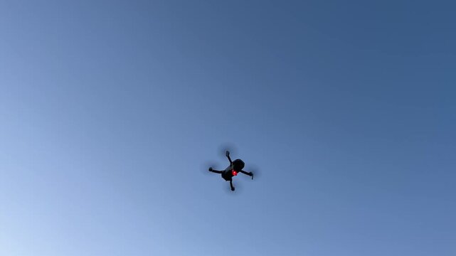 A drone flight in the twilight at sunset with red signal light