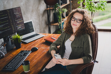 Photo of lovely confident successful woman software developer sitting armchair enjoy realx rest workstation indoors